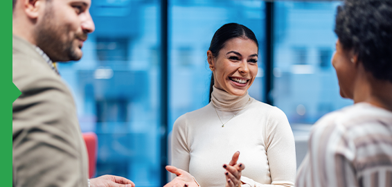 Colleagues engaged in a conversation at work in a contemporary office space. Colleagues engaged in a conversation at work in a contemporary office space.